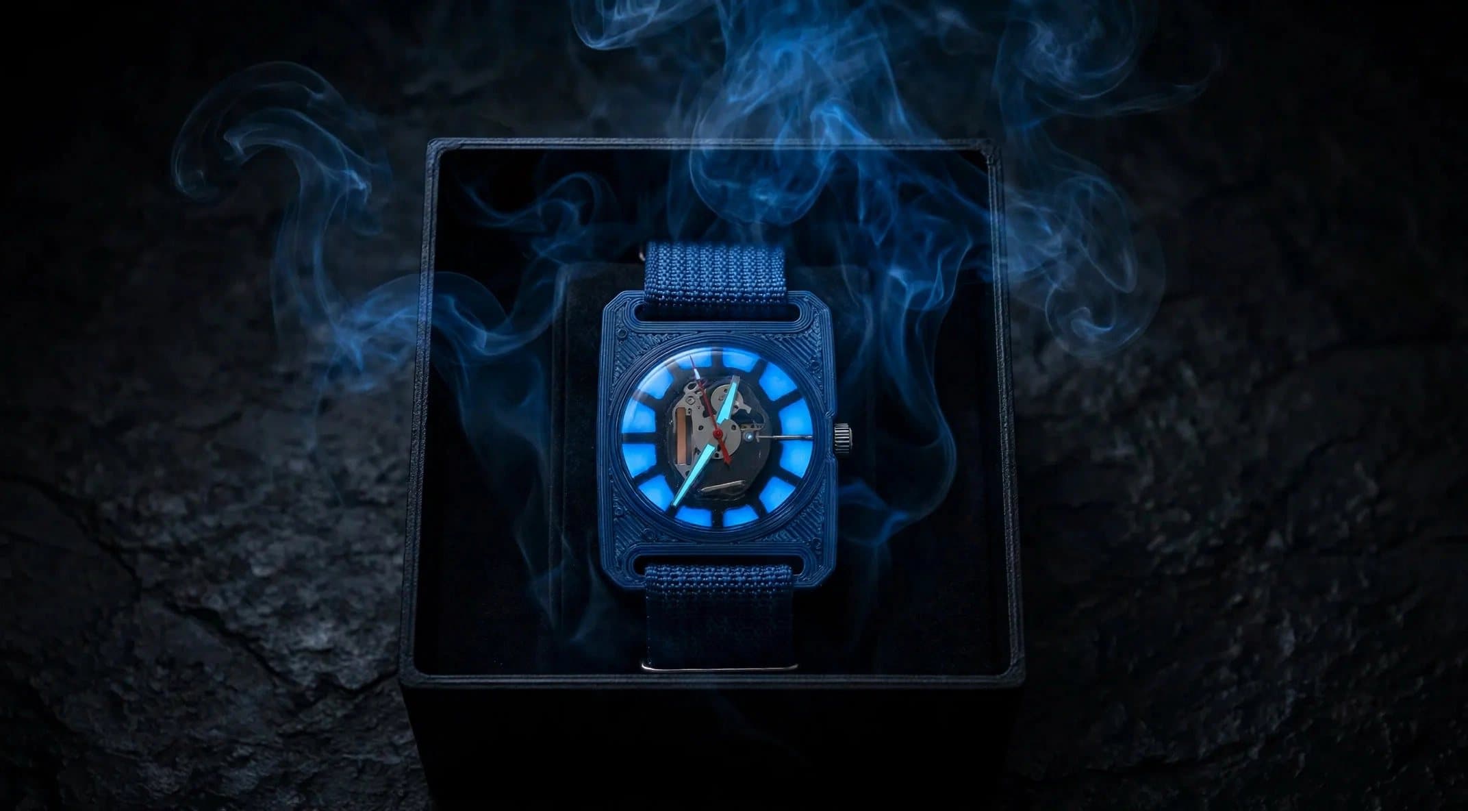 Edition 01 glowing in its open box, wreathed in blue smoke