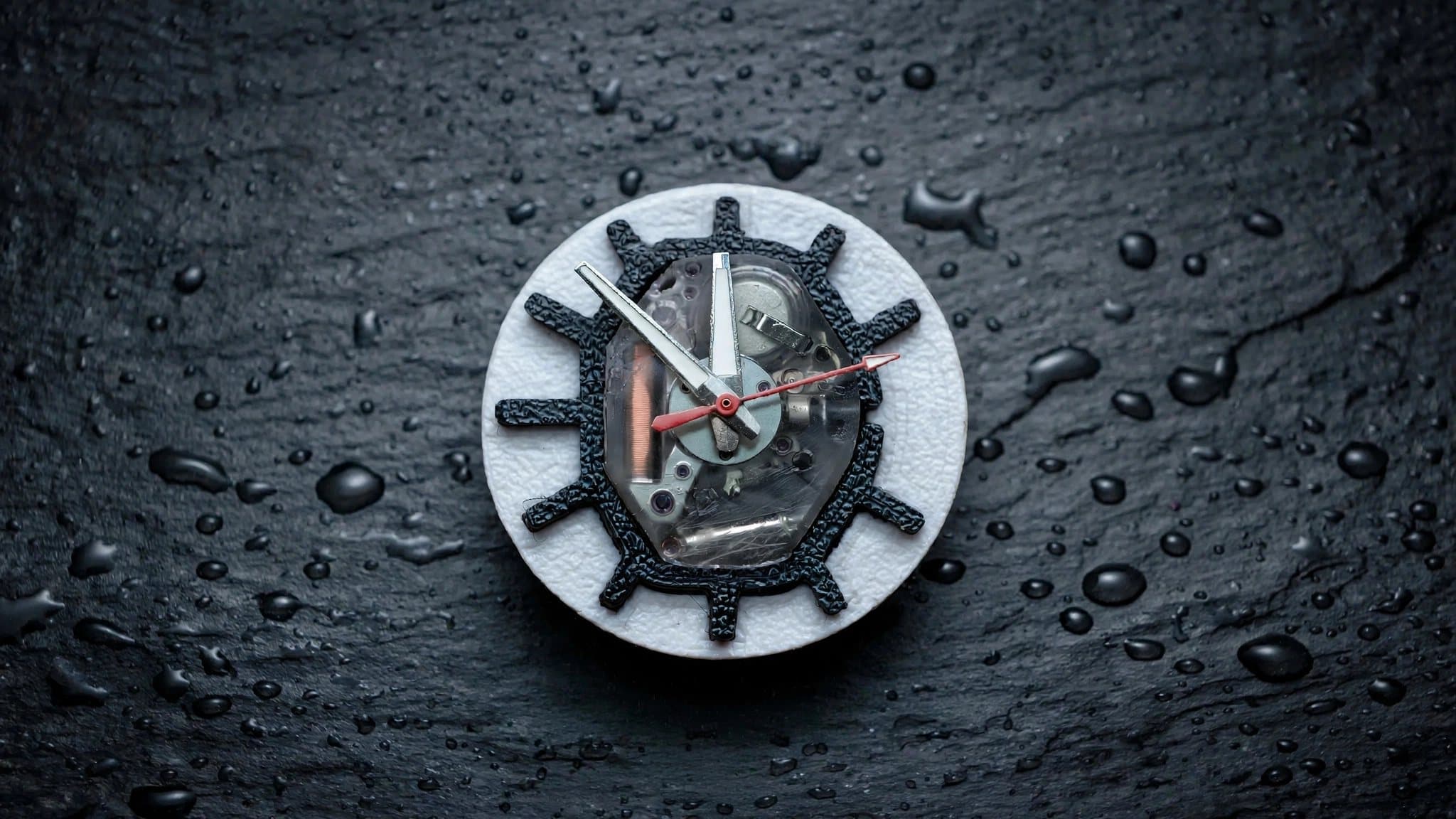The open skeleton dial and movement on wet slate